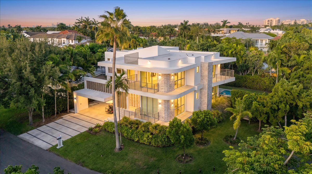 Aerial view of 315 Cypress Drive at twilight, with the Miami skyline on the horizon