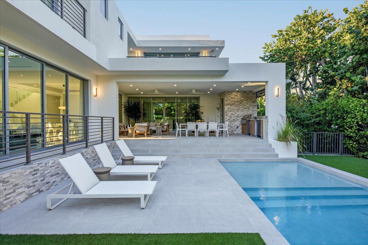 Wide stone steps leading from the terrace down to the pool deck