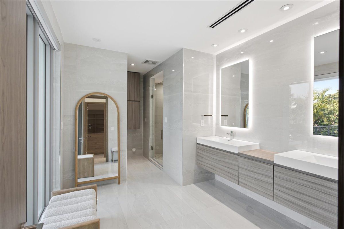 Primary bath with double floating vanities and walk-in shower