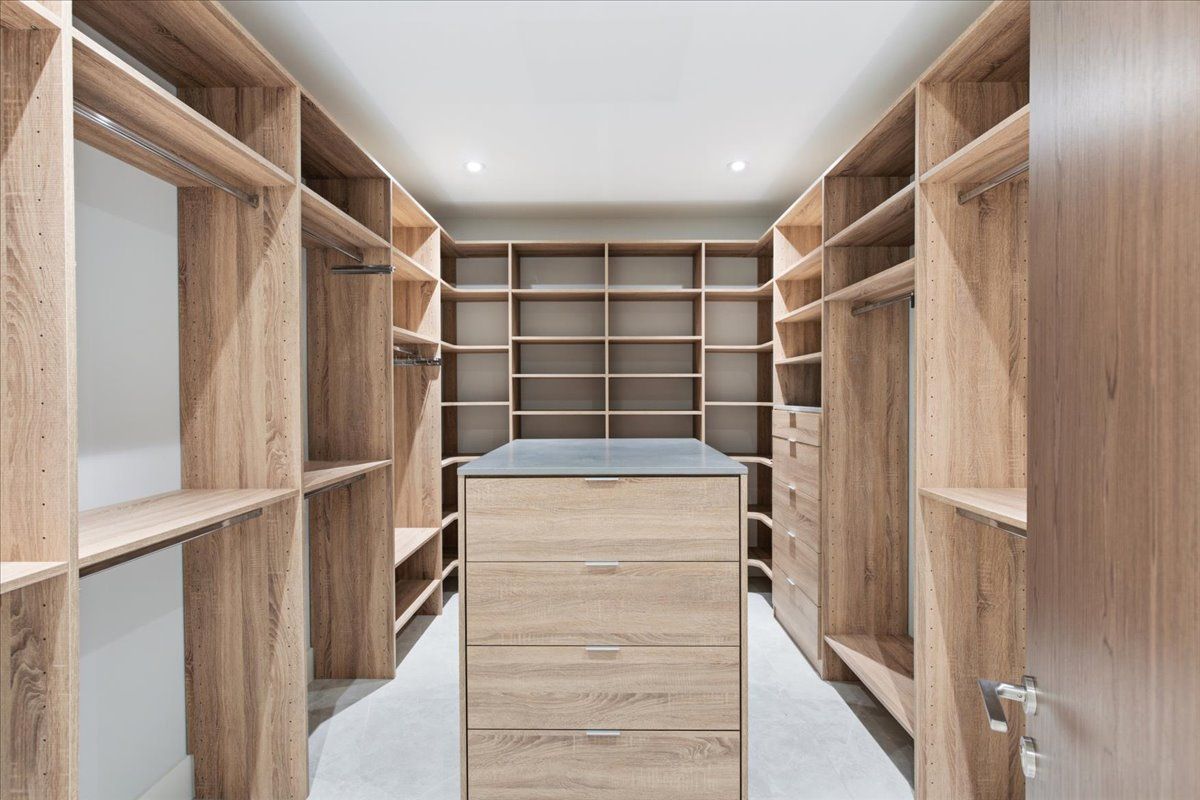 Primary walk-in closet with center island dresser
