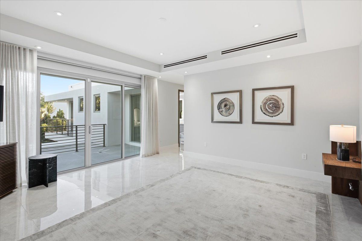 Primary bedroom with sliding glass doors open to a private terrace